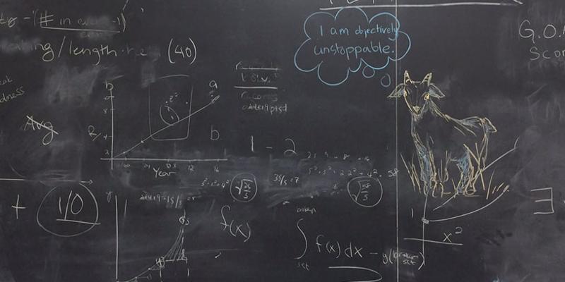 A blackboard with math equations and a doodle of a goat in chalk